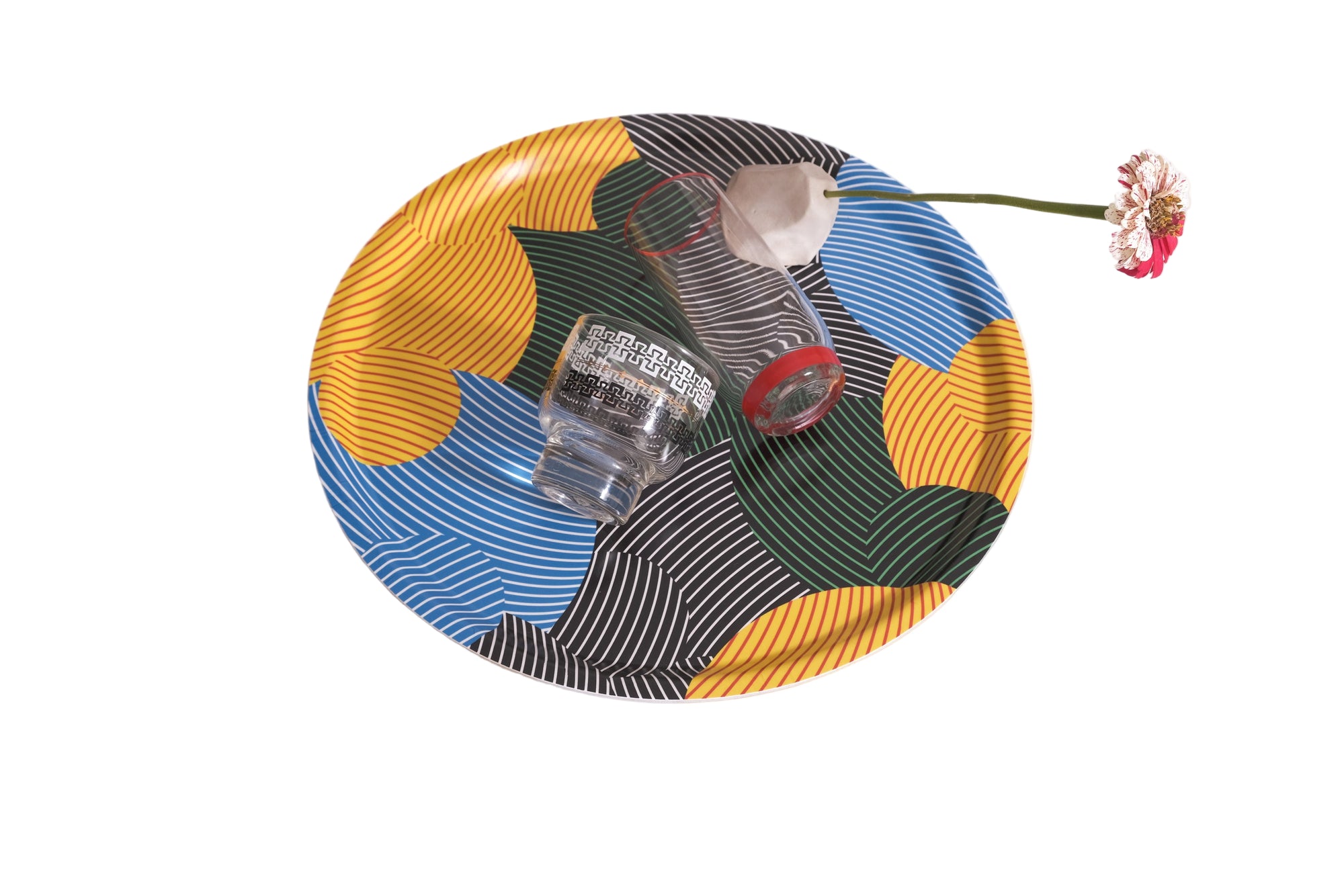 Colorful woven basket with glass containers and a flower on a white background